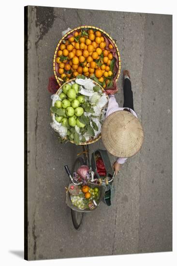 Street vendor with baskets of fruit on bicycle, Old Quarter, Hanoi, Vietnam-David Wall-Stretched Canvas