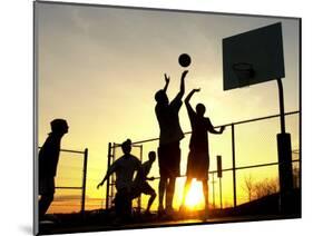 Students Play a Basketball Game as the Sun Sets at Bucks County Community College-null-Mounted Photographic Print