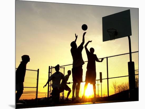 Students Play a Basketball Game as the Sun Sets at Bucks County Community College-null-Mounted Photographic Print