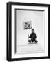 Studio Photos of Gloria Steinem Sitting on Floor with Sign That Says 'We Shall Overcome", 1965-Yale Joel-Framed Photographic Print