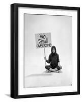 Studio Photos of Gloria Steinem Sitting on Floor with Sign That Says 'We Shall Overcome", 1965-Yale Joel-Framed Photographic Print