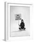 Studio Photos of Gloria Steinem Sitting on Floor with Sign That Says 'We Shall Overcome", 1965-Yale Joel-Framed Photographic Print