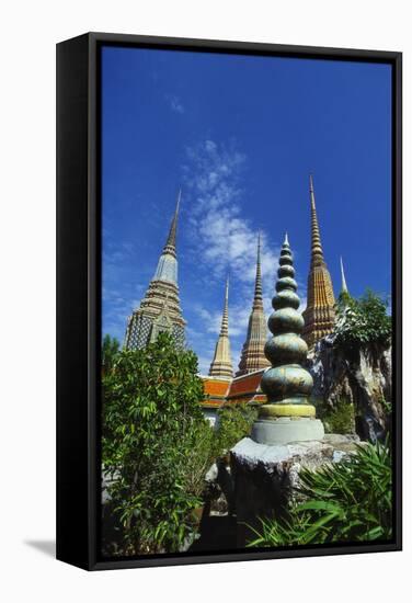 Stupas at the Temple of the Reclining Buddha, Bangkok, Thailand-Robert Francis-Framed Stretched Canvas