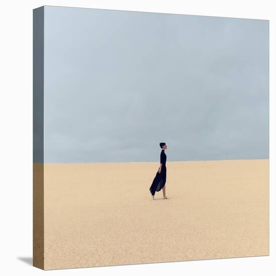 Stylish Girl in Black Clothes Walking in the Desert-Evgeniya Porechenskaya-Stretched Canvas
