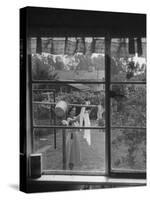 Suburban Housewife Hanging Out a Bit of Laundry, Seen Through Window in typical California Home-Loomis Dean-Stretched Canvas
