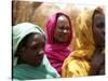 Sudanese Refugees Stand Near Their Huts-null-Stretched Canvas