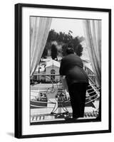 Suit Clad Movie Director Alfred Hitchcock as He Leans on Balcony Railing of Apartment-Peter Stackpole-Framed Premium Photographic Print