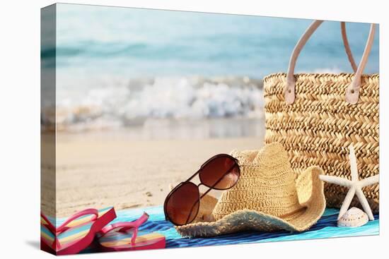 Summer Beach Bag with Straw Hat,Towel,Sunglasses and Flip Flops on Sandy Beach-Sofiaworld-Stretched Canvas