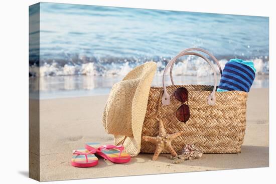 Summer Beach Bag with Straw Hat,Towel,Sunglasses and Flip Flops on Sandy Beach-Liang Zhang-Stretched Canvas