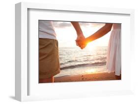 Summer Couple Holding Hands at Sunset on Beach. Romantic Young Couple Enjoying Sun, Sunshine, Roman-Maridav-Framed Photographic Print