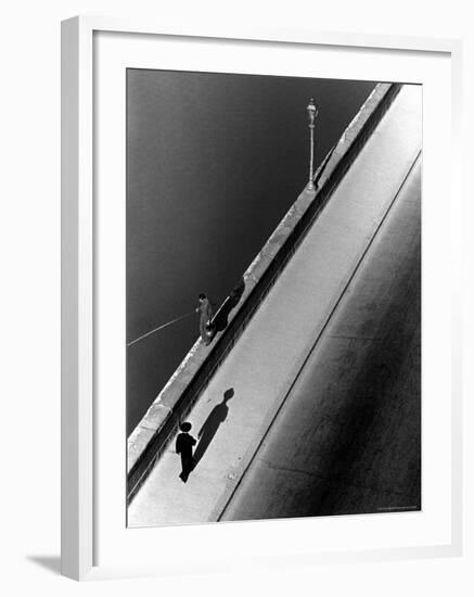 Sunday Morning Along the Arno River, a Man Fishing, and a Passerby Casting a Shadow-Alfred Eisenstaedt-Framed Photographic Print