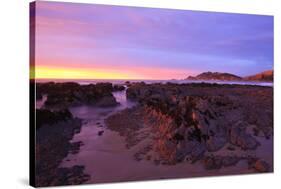 Sunrise Casts a Red Pink Hue on Rocks of a Beach Looking Towards Nugget Point-Eleanor-Stretched Canvas