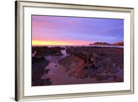 Sunrise Casts a Red Pink Hue on Rocks of a Beach Looking Towards Nugget Point-Eleanor-Framed Photographic Print