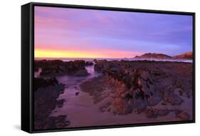 Sunrise Casts a Red Pink Hue on Rocks of a Beach Looking Towards Nugget Point-Eleanor-Framed Stretched Canvas