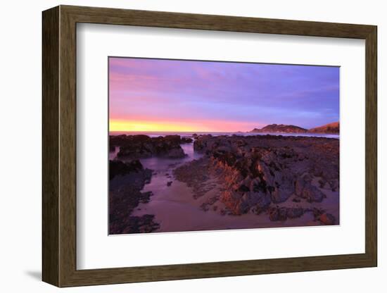 Sunrise Casts a Red Pink Hue on Rocks of a Beach Looking Towards Nugget Point-Eleanor-Framed Photographic Print