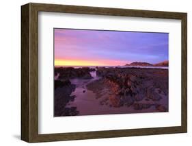 Sunrise Casts a Red Pink Hue on Rocks of a Beach Looking Towards Nugget Point-Eleanor-Framed Photographic Print