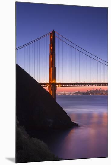 Sunrise Of A Single Bridge Of The Golden Gate Bridge, With The San Francisco Skyline And Bay Bridge-Joe Azure-Mounted Photographic Print