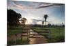 Sunset at the Gate of a Bonito Farm, with Rolling Hills in the Background-Alex Saberi-Mounted Photographic Print