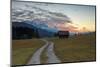 Sunset on wooden huts and meadows with the Alps in background, Geroldsee, Krun, Garmisch Partenkirc-Roberto Moiola-Mounted Photographic Print