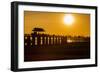 Sunset over the lake near wooden footbridge, Myanmar.-Michele Niles-Framed Photographic Print