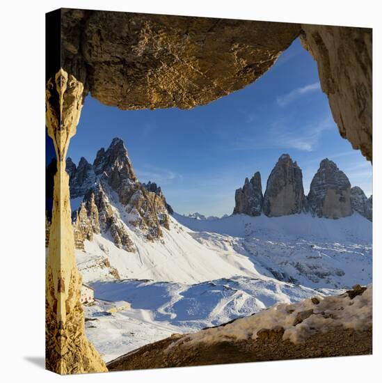 Sunset over the snow capped Tre Cime di Lavaredo and Monte Paterno seen from rock cave-Roberto Moiola-Stretched Canvas