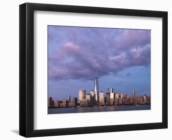 Sunset reflects off the buildings of lower Manhattan, seen from the water, New York City, New York.-Brenda Tharp-Framed Photographic Print