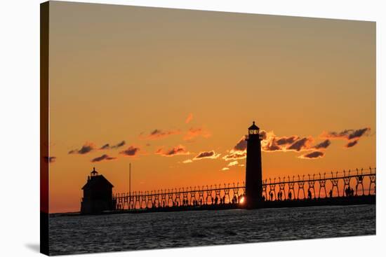 Sunset Silhouettes the Grand Haven Lighthouse in Grand Haven, Michigan, Usa-Chuck Haney-Stretched Canvas