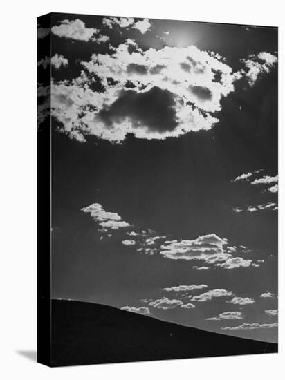 Sunshine Filled Clouds Against Dark Sky, Above Dark Dune in Middle of Kalahan Desert, Bechuanaland-Nat Farbman-Stretched Canvas