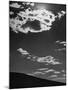 Sunshine Filled Clouds Against Dark Sky, Above Dark Dune in Middle of Kalahan Desert, Bechuanaland-Nat Farbman-Mounted Photographic Print