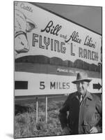 Super Rich Texas Millionaires William Likins Standing in Front of Sign at Main Entrance to Ranch-Michael Rougier-Mounted Premium Photographic Print