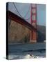 Surfer Rides a Wave Near the Golden Gate Bridge in San Francisco-null-Stretched Canvas