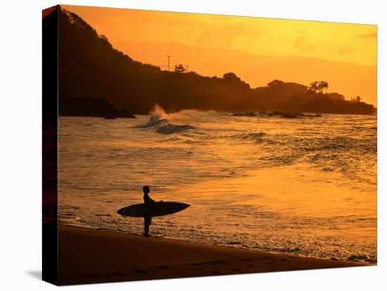 Surfer Standing at Waimea Bay at Sunset, Waimea, U.S.A.-Ann Cecil-Stretched Canvas