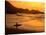 Surfer Standing at Waimea Bay at Sunset, Waimea, U.S.A.-Ann Cecil-Stretched Canvas