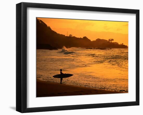 Surfer Standing at Waimea Bay at Sunset, Waimea, U.S.A.-Ann Cecil-Framed Premium Photographic Print