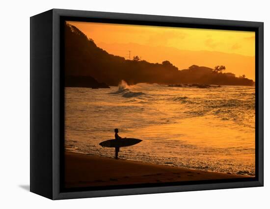 Surfer Standing at Waimea Bay at Sunset, Waimea, U.S.A.-Ann Cecil-Framed Stretched Canvas