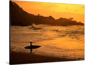 Surfer Standing at Waimea Bay at Sunset, Waimea, U.S.A.-Ann Cecil-Stretched Canvas