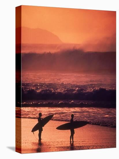 Surfers at Sunset, Oahu, Hawaii-Bill Romerhaus-Stretched Canvas