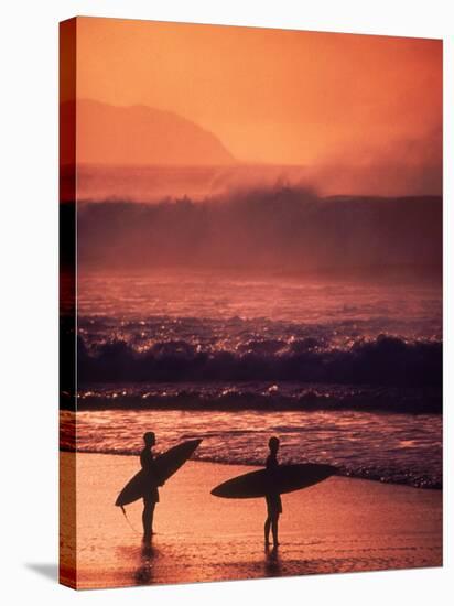 Surfers at Sunset, Oahu, Hawaii-Bill Romerhaus-Stretched Canvas