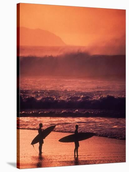 Surfers at Sunset, Oahu, Hawaii-Bill Romerhaus-Stretched Canvas