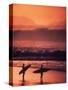 Surfers at Sunset, Oahu, Hawaii-Bill Romerhaus-Stretched Canvas