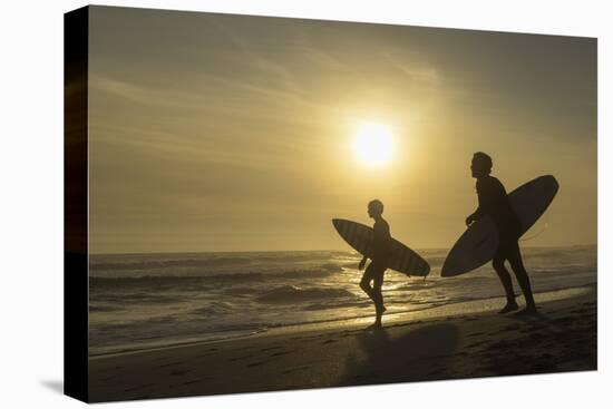 Surfers on Bloubergstrand at sunset, Cape Town, Western Cape, South Africa, Africa-Ian Trower-Stretched Canvas