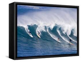 Surfers Ride a Wave at Waimea Beach on the North Shore of Oahu, Hawaii-null-Framed Stretched Canvas