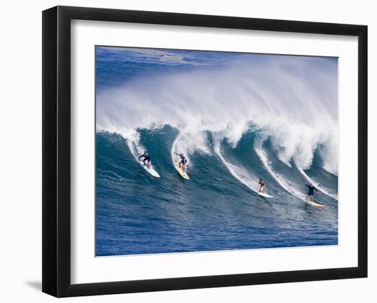 Surfers Ride a Wave at Waimea Beach on the North Shore of Oahu, Hawaii-null-Framed Premium Photographic Print