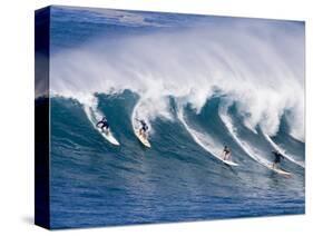 Surfers Ride a Wave at Waimea Beach on the North Shore of Oahu, Hawaii-null-Stretched Canvas