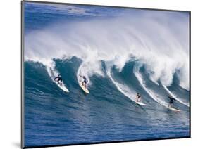 Surfers Ride a Wave at Waimea Beach on the North Shore of Oahu, Hawaii-null-Mounted Photographic Print