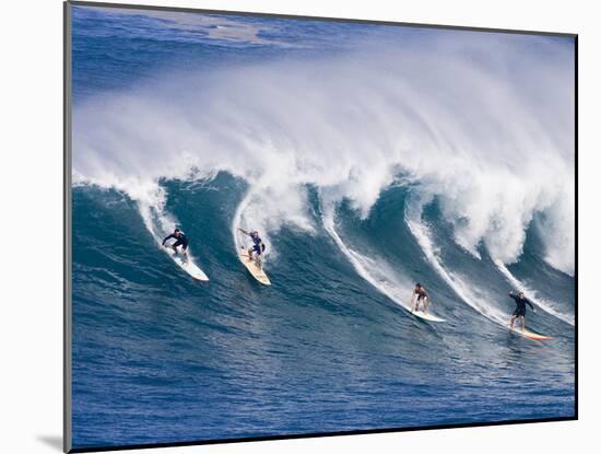 Surfers Ride a Wave at Waimea Beach on the North Shore of Oahu, Hawaii-null-Mounted Photographic Print