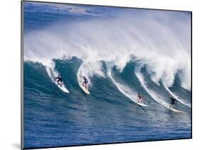 Surfers Ride a Wave at Waimea Beach on the North Shore of Oahu, Hawaii-null-Mounted Photographic Print