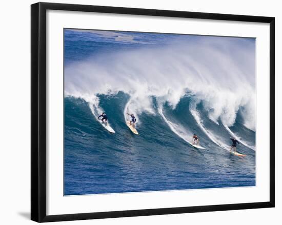 Surfers Ride a Wave at Waimea Beach on the North Shore of Oahu, Hawaii-null-Framed Photographic Print