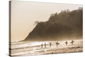 Surfers surfing on a beach at sunset, Nosara, Guanacaste Province, Pacific Coast, Costa Rica-Matthew Williams-Ellis-Stretched Canvas