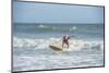 Surfing Santas, Cocoa Beach, Florida, USA-Lisa Engelbrecht-Mounted Photographic Print